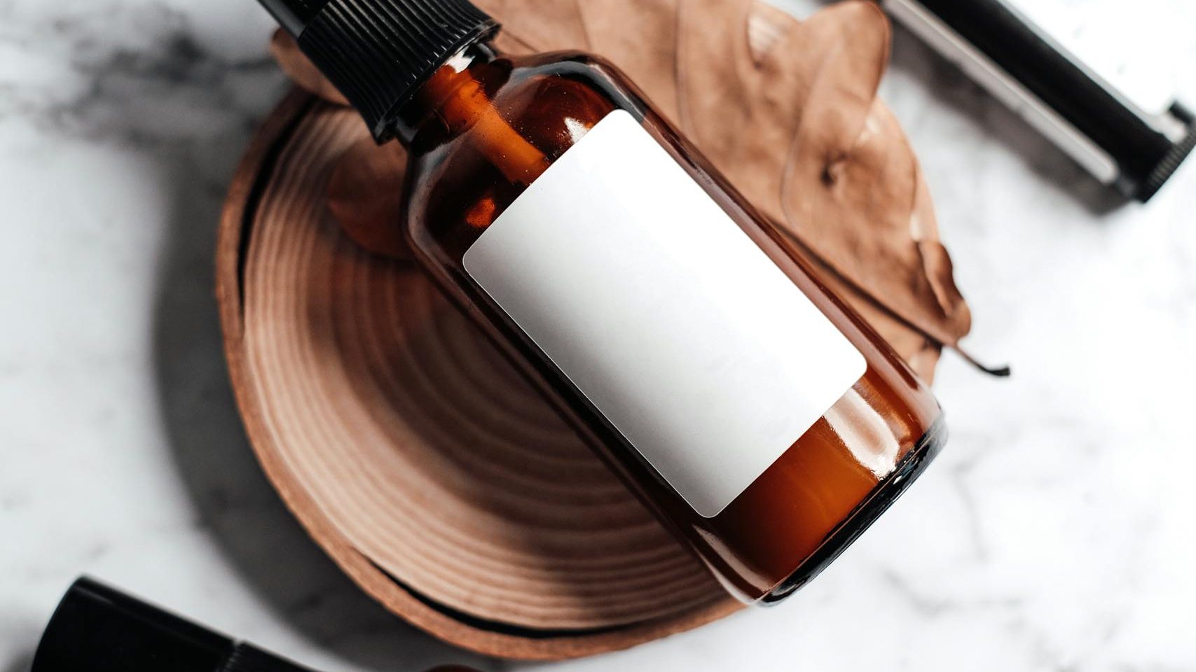 Stylish product shot featuring bottles with labels on a marble surface.